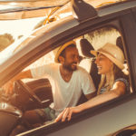 young adults in car laughing